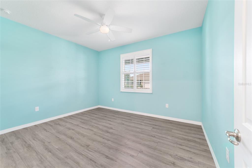 10064 Southwest 88th Street Ocala, FL 34481 - Photo 32 of 47 an empty room with wooden floor and windows