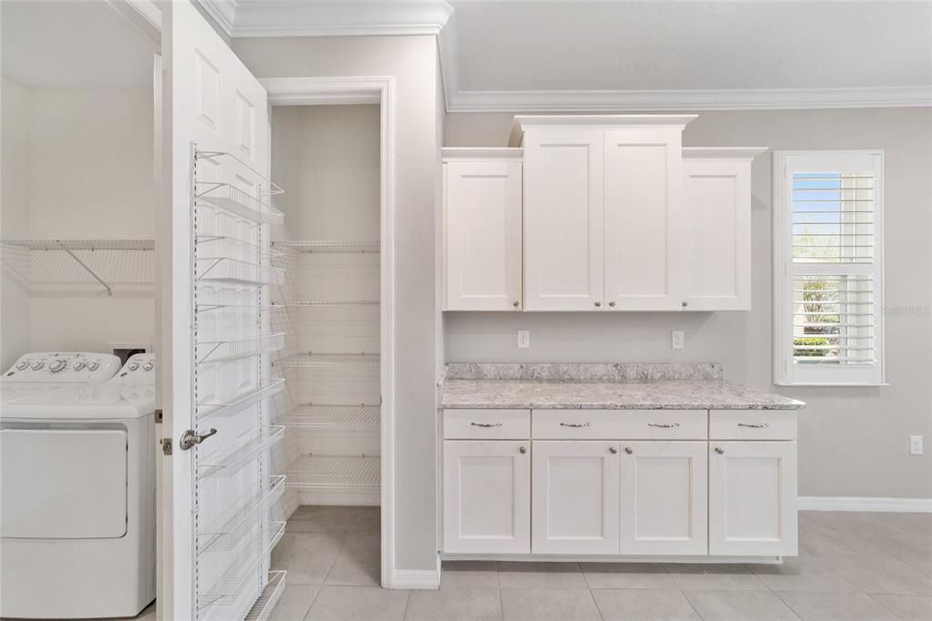 10064 Southwest 88th Street Ocala, FL 34481 - Photo 34 of 47 a kitchen with white cabinets and sink
