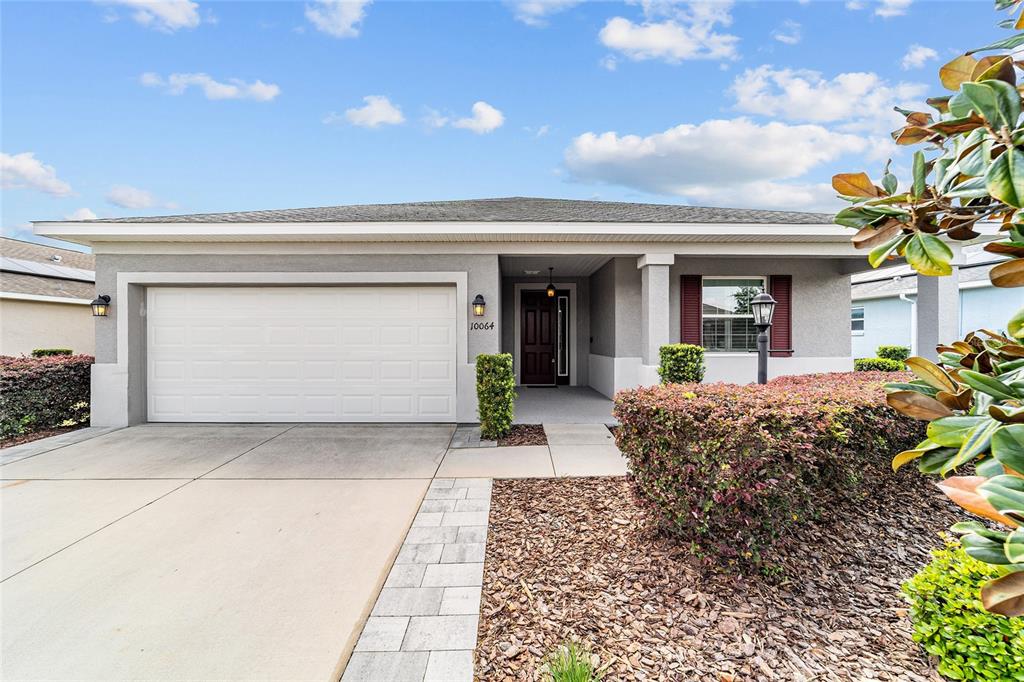 10064 Southwest 88th Street Ocala, FL 34481 - Photo 42 of 47 a front view of a house with garden