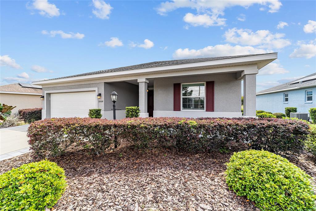 10064 Southwest 88th Street Ocala, FL 34481 - Photo 44 of 47 a front view of a house with garden