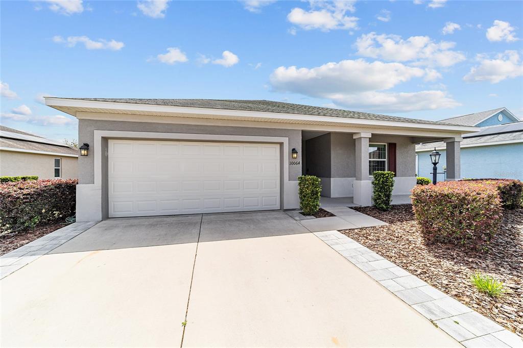 10064 Southwest 88th Street Ocala, FL 34481 - Photo 6 of 47 a front view of a house with a garage