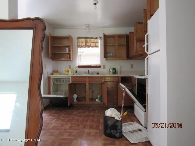 238 Ryan Road Blakeslee, PA 18610 - Photo 3 of 3 a room with a chair and white cabinets