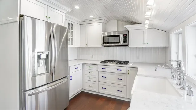 a kitchen with stainless steel appliances a refrigerator stove and microwave