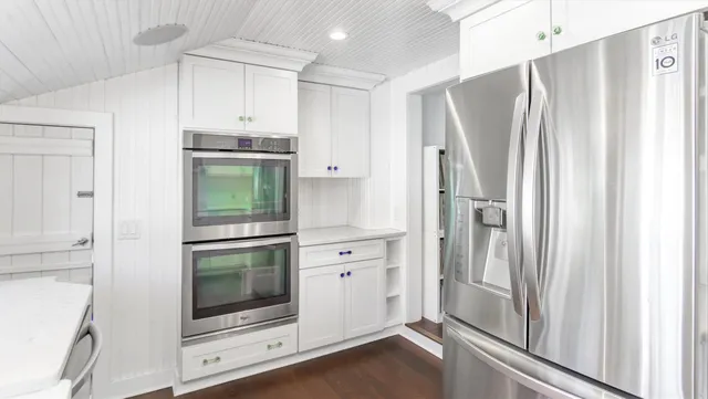 a kitchen with stainless steel appliances a refrigerator and cabinets