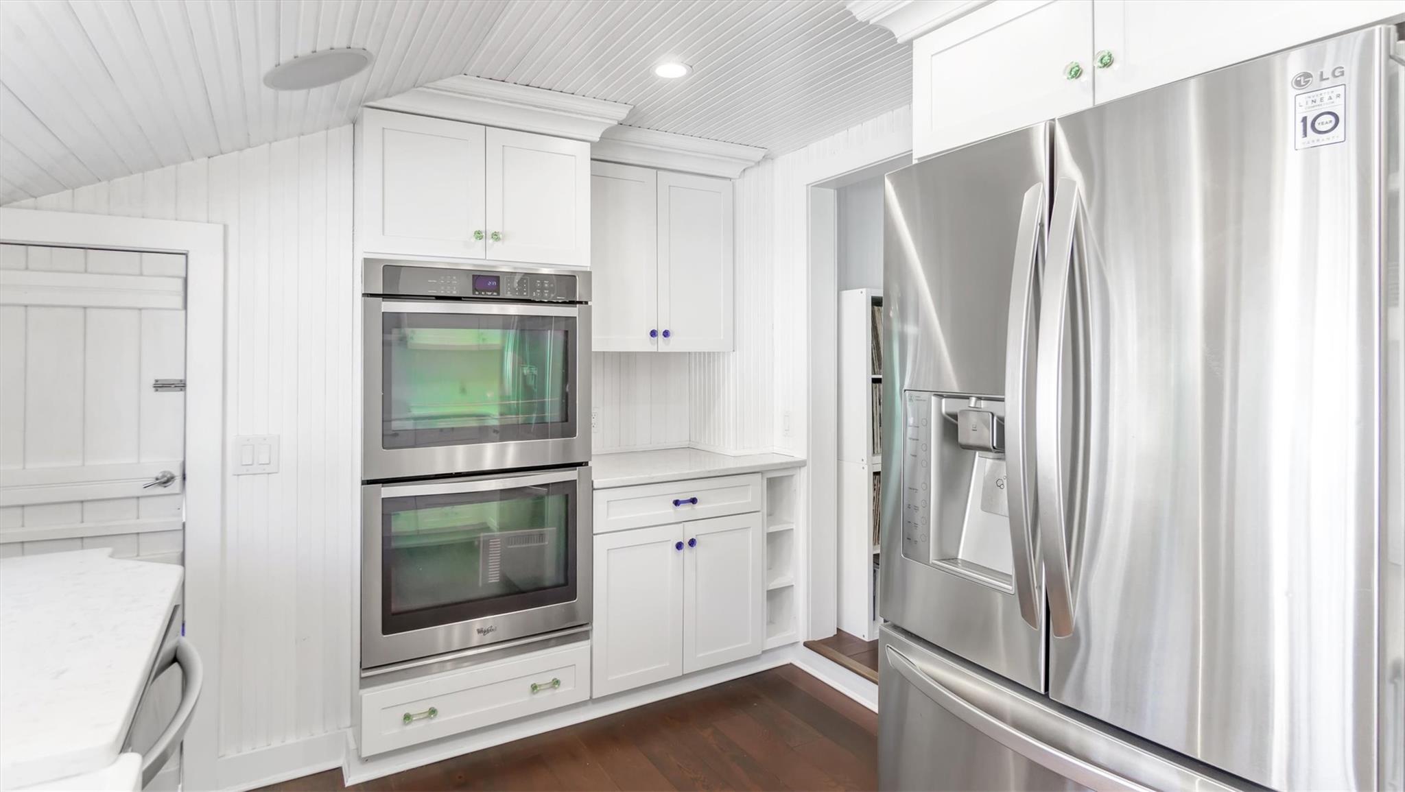 234 Dune Road Quogue, NY 11959 - Photo 13 of 34 a kitchen with stainless steel appliances a refrigerator and cabinets
