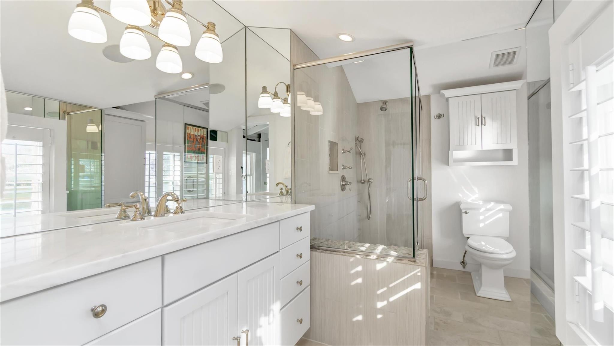 234 Dune Road Quogue, NY 11959 - Photo 21 of 34 a bathroom with a shower sink vanity mirror and toilet