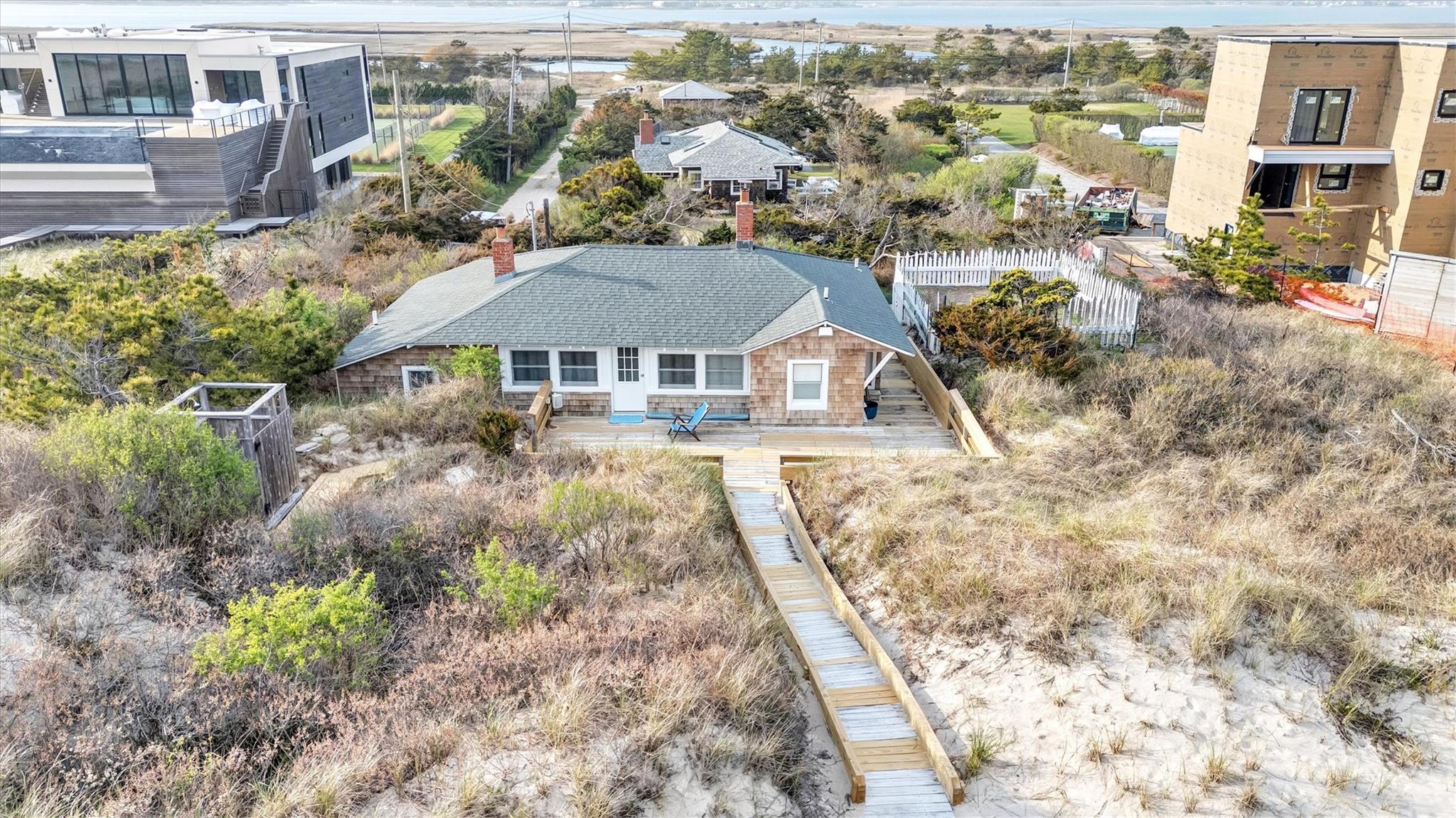 234 Dune Road Quogue, NY 11959 - Photo 23 of 34 a view of a house with a yard and plants