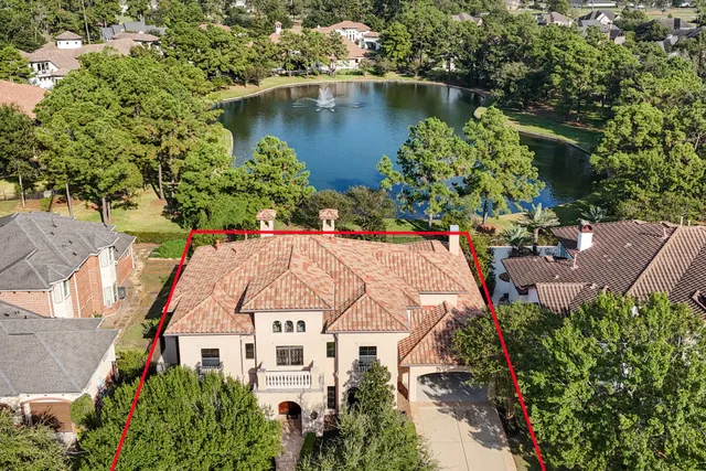 an aerial view of a house with a lake view