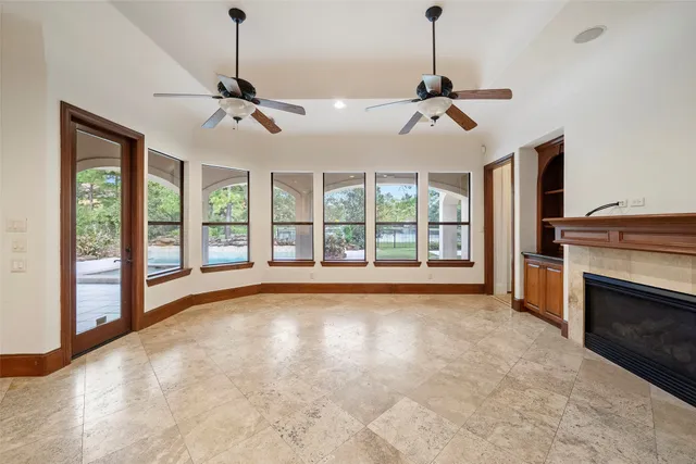 a view of an empty room with a fireplace and a window