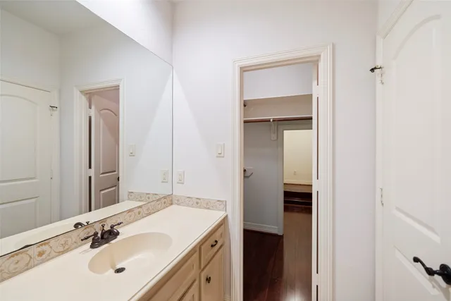 a bathroom with a sink vanity and mirror