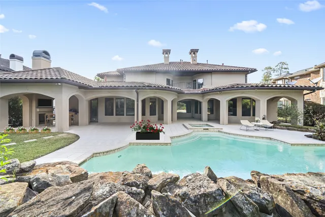 a view of a house with swimming pool and a yard