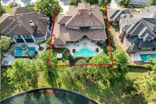 an aerial view of multiple houses with a yard