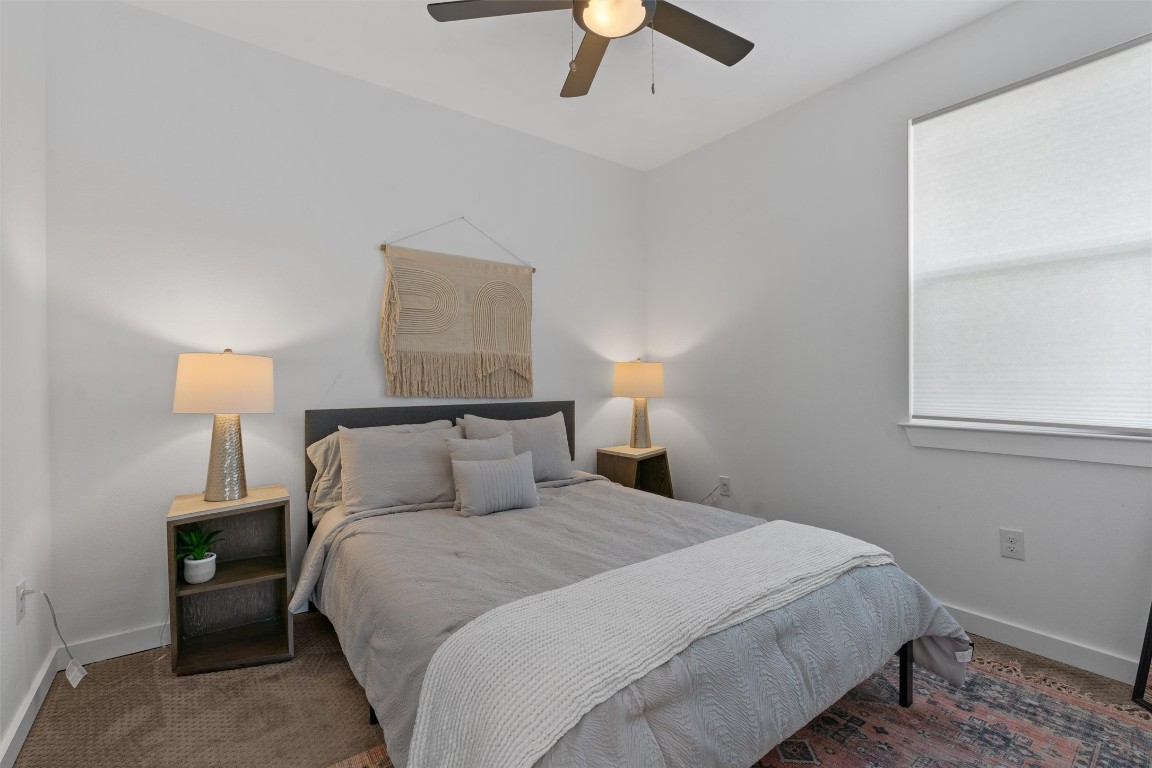 2411 East 11th Street, Unit 1 Austin, TX 78702 - Photo 10 of 17 a bedroom with a bed and a lamp
