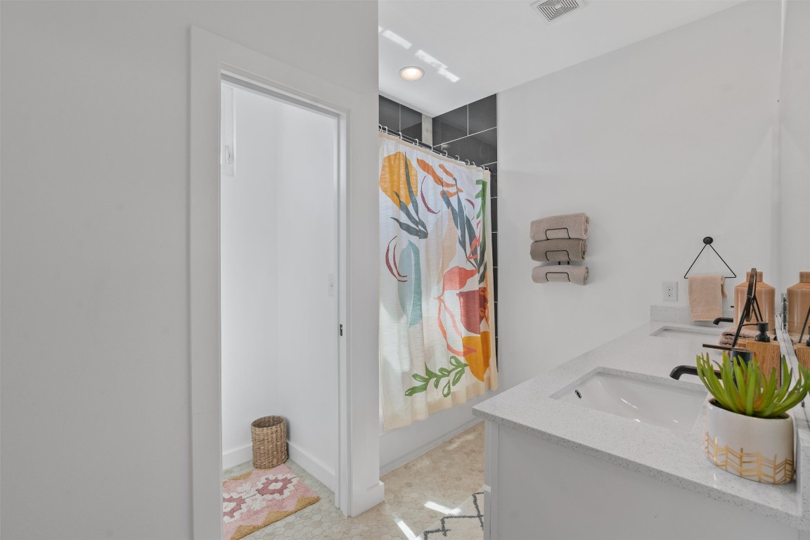 2411 East 11th Street, Unit 1 Austin, TX 78702 - Photo 12 of 17 a bathroom with a sink and a mirror