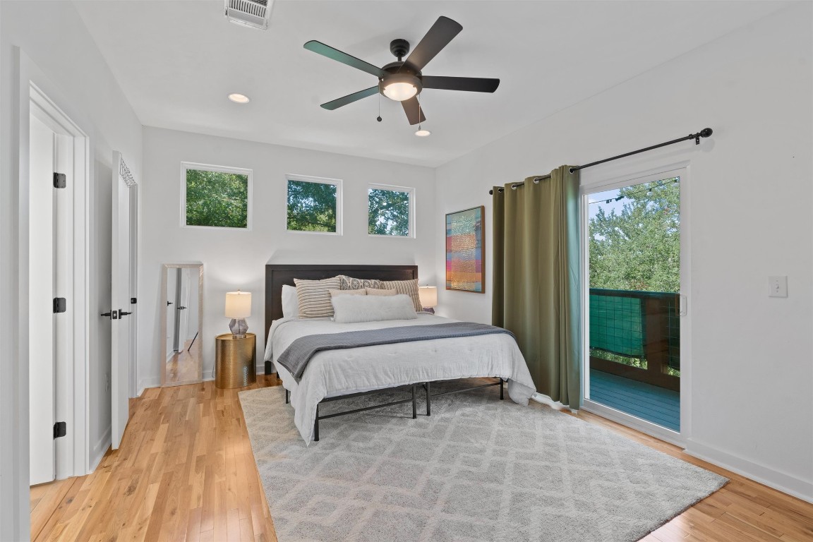 2411 East 11th Street, Unit 1 Austin, TX 78702 - Photo 4 of 17 a bed room with a bed and a chandelier