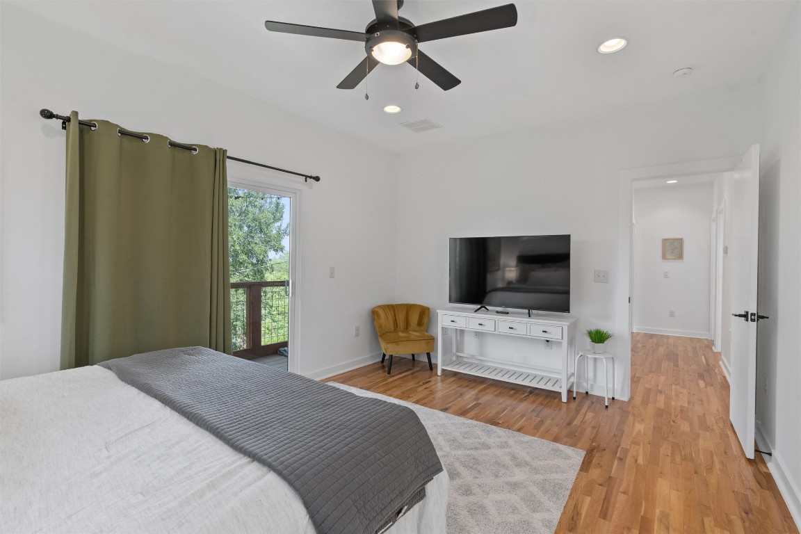 2411 East 11th Street, Unit 1 Austin, TX 78702 - Photo 8 of 17 a bedroom with a bed and a flat screen tv