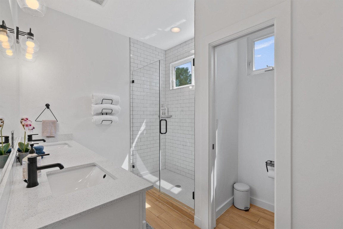 2411 East 11th Street, Unit 1 Austin, TX 78702 - Photo 9 of 17 a bathroom with a sink a toilet and a shower