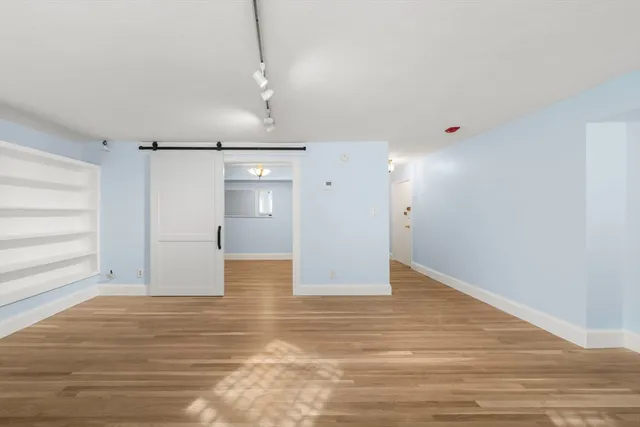 a kitchen with granite countertop white cabinets and black appliances