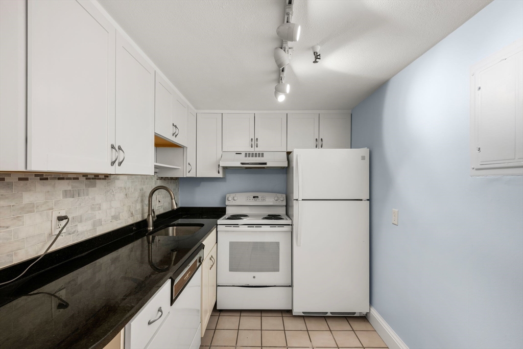 242 Beacon Street, Unit 1 Boston, MA 02116 - Photo 16 of 29 a kitchen with a white cabinets and white appliances