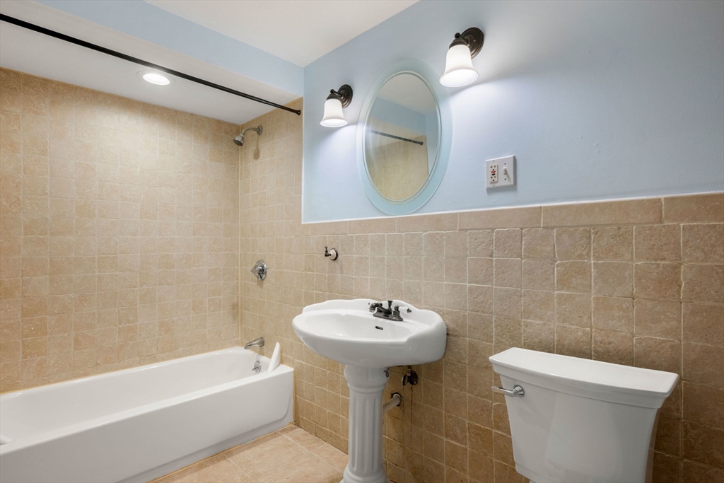 242 Beacon Street, Unit 1 Boston, MA 02116 - Photo 19 of 29 a bathroom with a sink a mirror toilet and bathtub