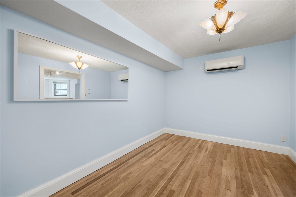 242 Beacon Street, Unit 1 Boston, MA 02116 - Photo 22 of 29 a view of a room with wooden floor and a window