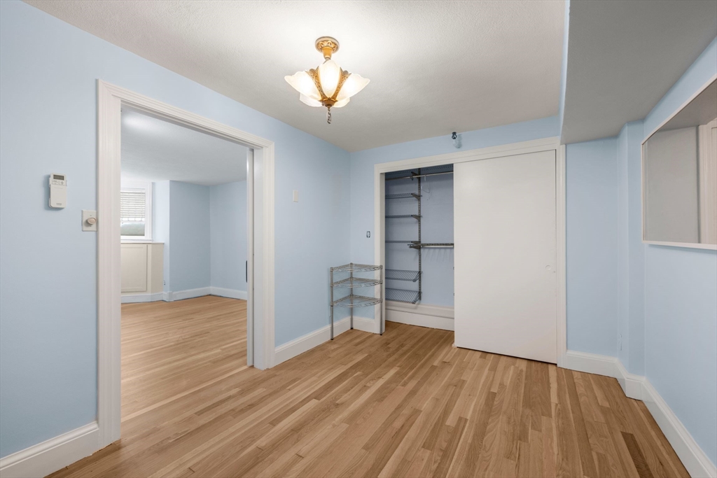 242 Beacon Street, Unit 1 Boston, MA 02116 - Photo 23 of 29 wooden floor in an empty room with a window
