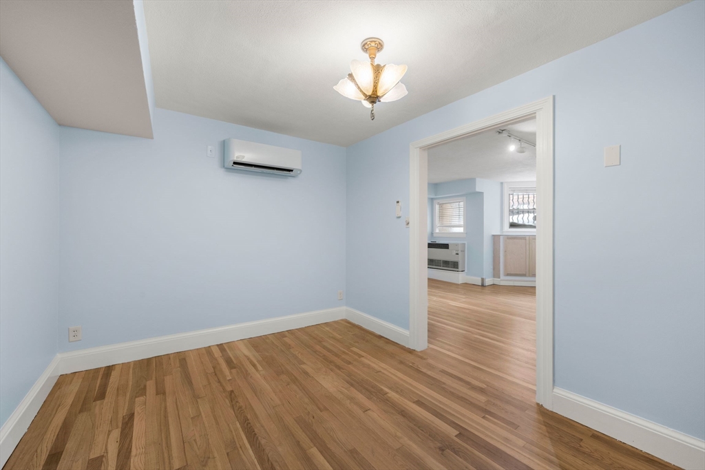 242 Beacon Street, Unit 1 Boston, MA 02116 - Photo 24 of 29 wooden floor in an empty room with a window