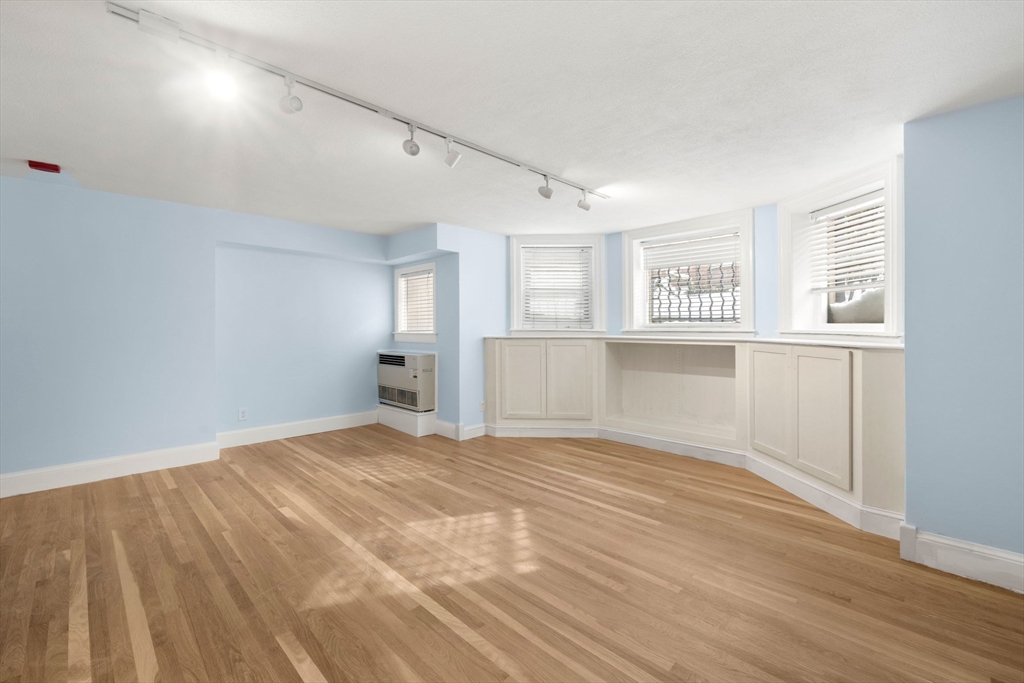 242 Beacon Street, Unit 1 Boston, MA 02116 - Photo 3 of 29 wooden floor in an empty room with a window