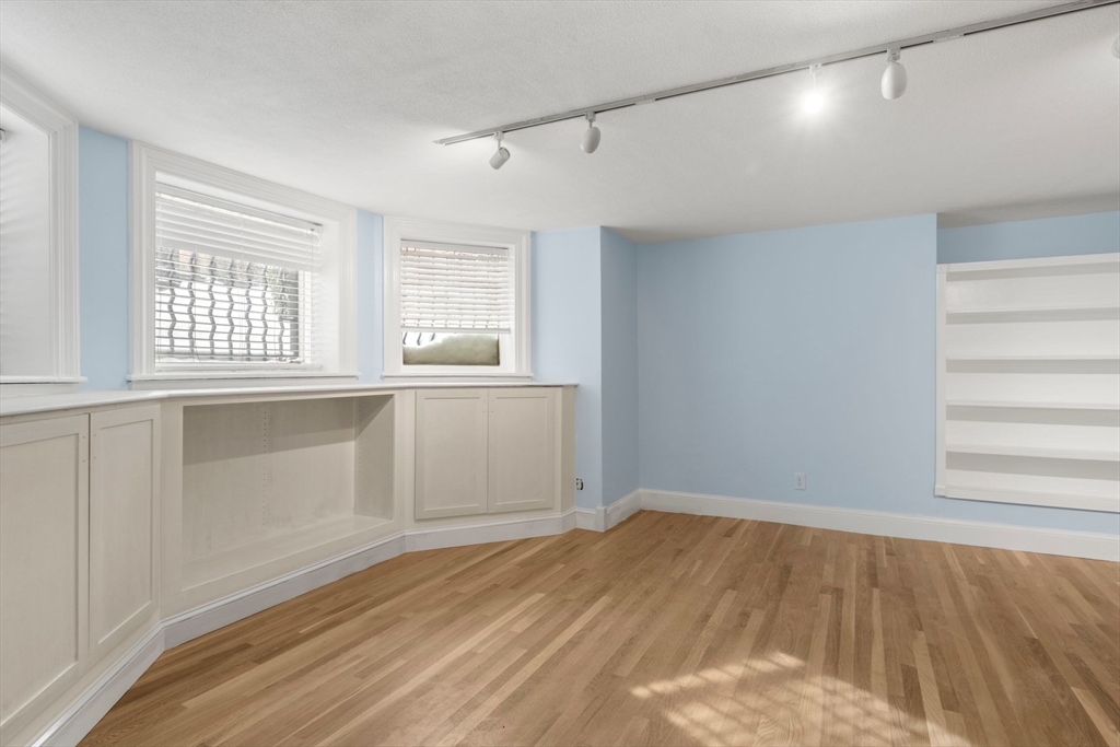 242 Beacon Street, Unit 1 Boston, MA 02116 - Photo 4 of 29 a view of empty room with wooden floor and fan