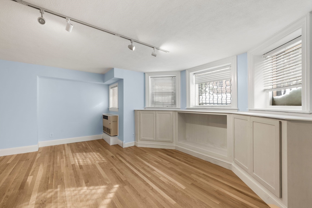 242 Beacon Street, Unit 1 Boston, MA 02116 - Photo 6 of 29 a view of empty room with wooden floor and fan