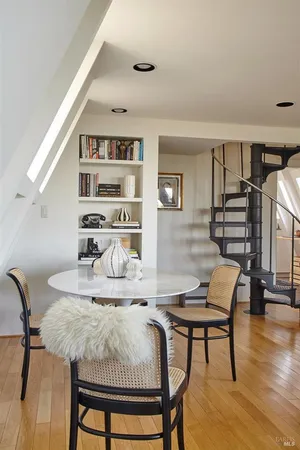 a dining room with furniture and wooden floor