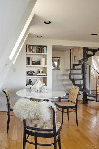 a dining room with furniture and wooden floor