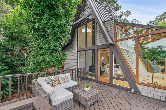 a view of deck with furniture and trees