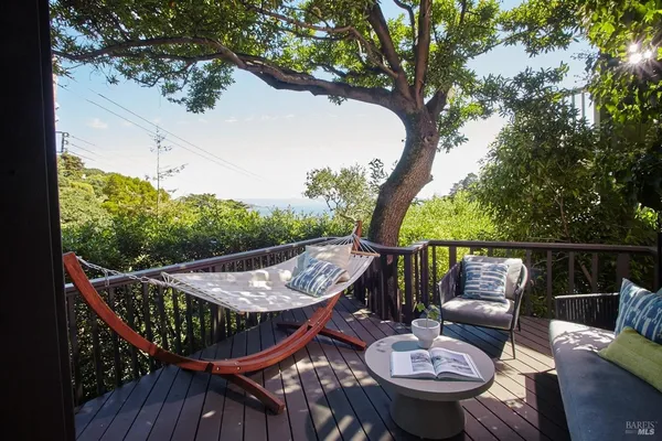 a view of a roof deck with furniture