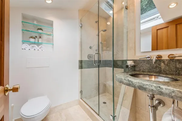 a bathroom with a granite countertop sink a mirror and a bathtub