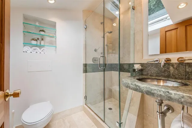 a bathroom with a granite countertop sink a mirror and a bathtub