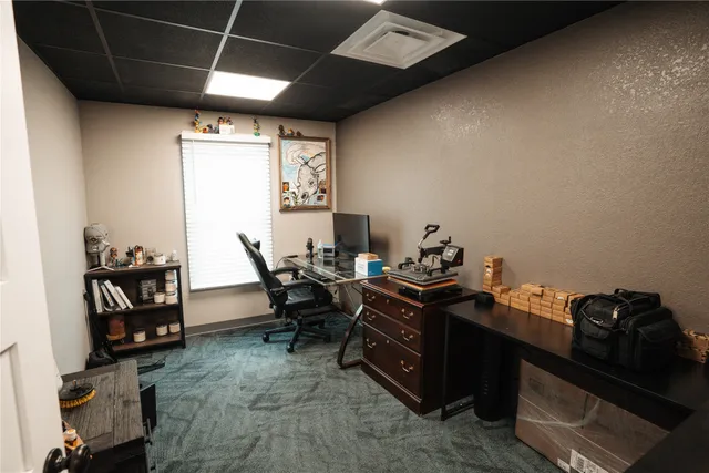 a view of a workspace with furniture