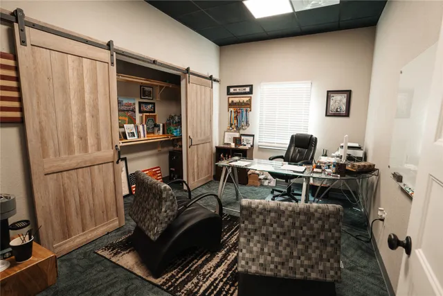 a living room with furniture a rug and a window