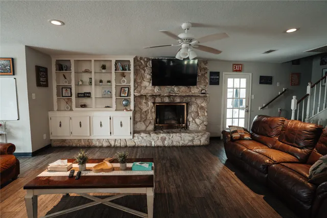 a living room with furniture fireplace and flat screen tv