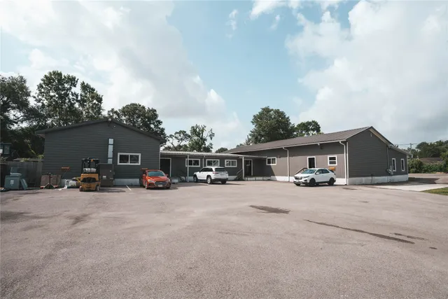 a view of a house with patio and a yard