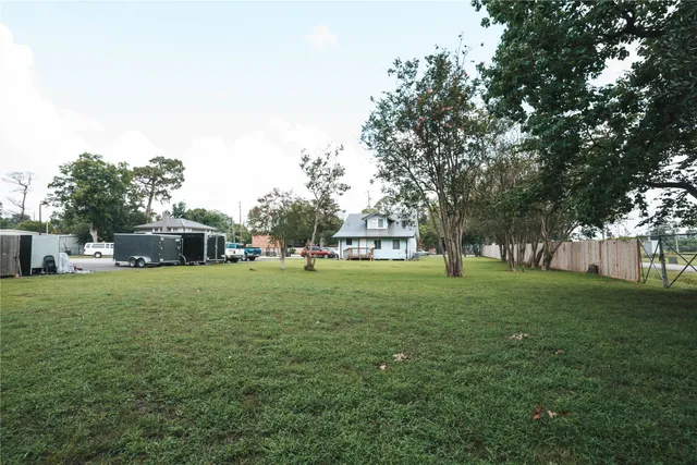a view of a trees and yard in front of a house