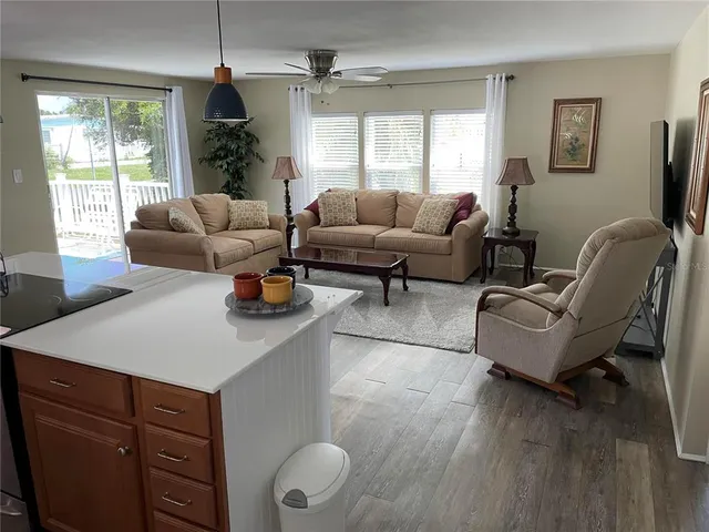 a kitchen with stainless steel appliances a table chairs and a refrigerator
