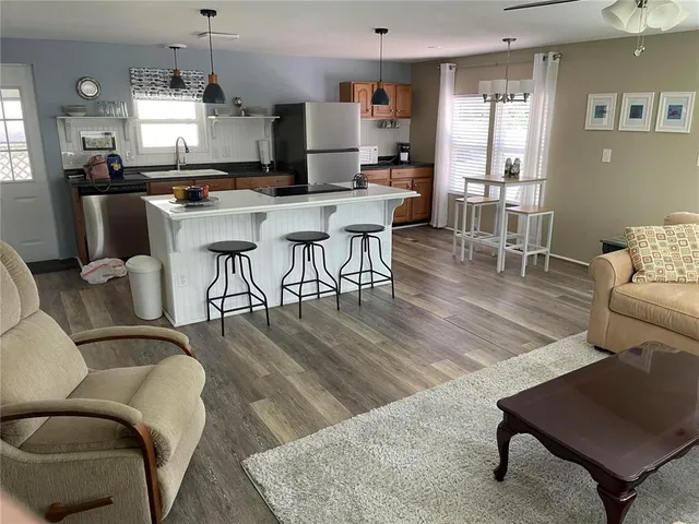 a bathroom with a granite countertop shower a mirror and a sink