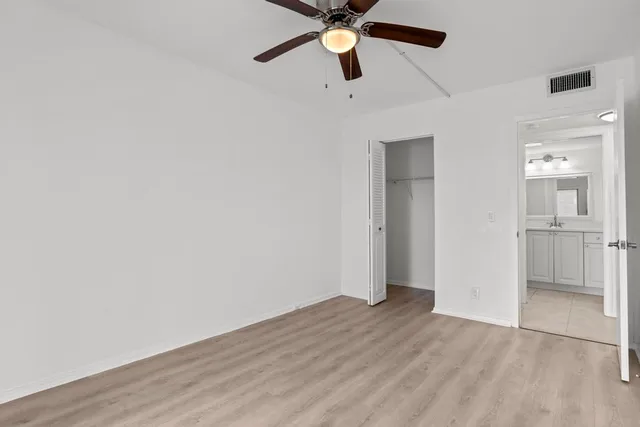 a bathroom with a toilet a sink a mirror and bathtub
