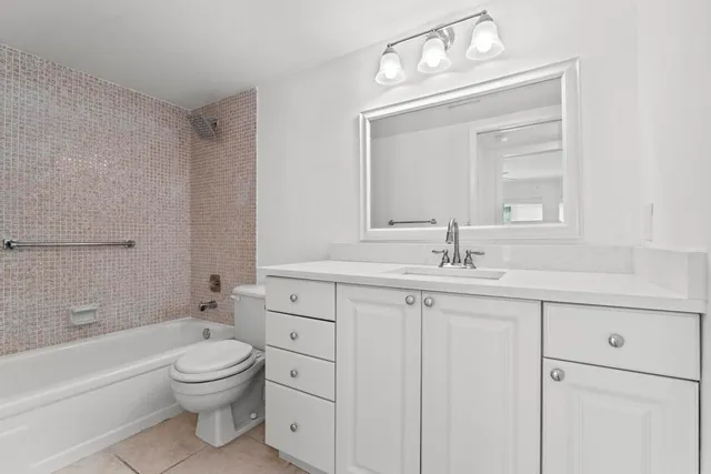 an empty room with fan and window