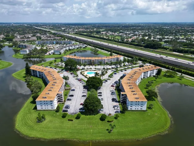 an aerial view of a swimming pool patio and outdoor seating