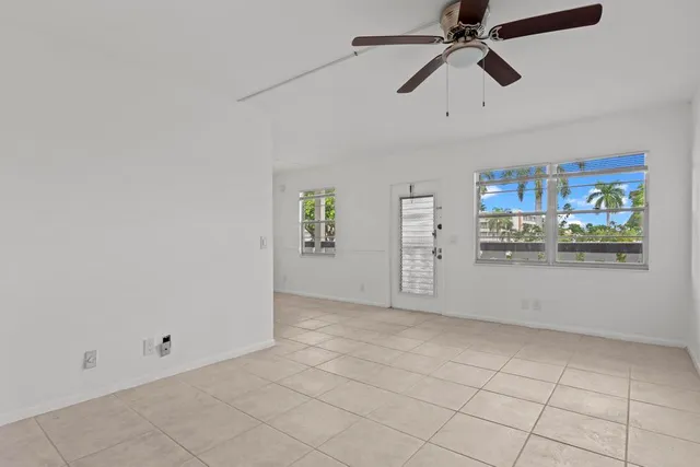 a view of a kitchen with wooden floor and a ceiling fan