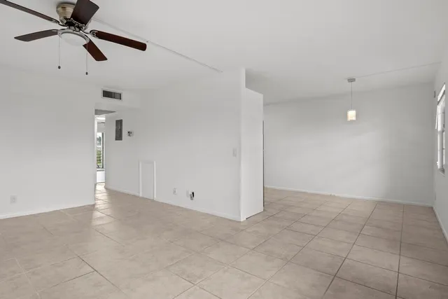 a kitchen with a refrigerator a stove top oven and cabinets