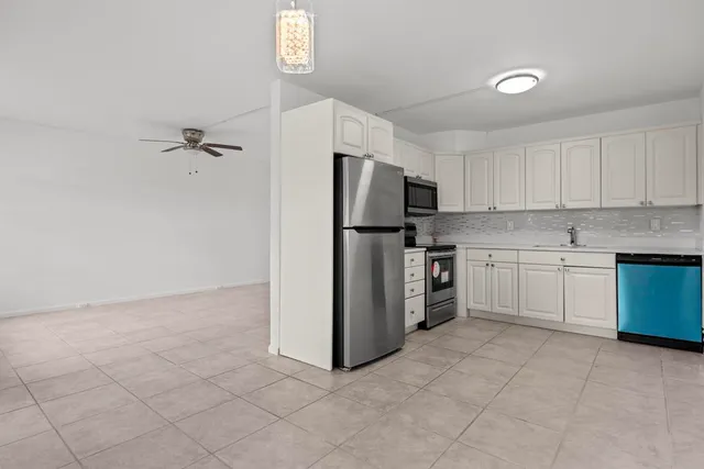 a kitchen with a refrigerator stove and microwave
