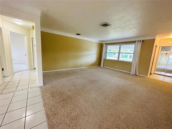 a view of an empty room with a window